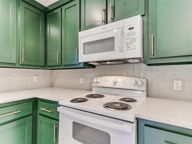 kitchen with tasteful backsplash, white appliances, and green cabinetry