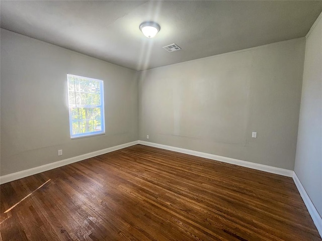 spare room with dark hardwood / wood-style floors