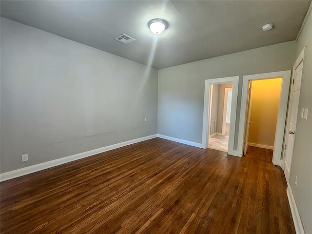 unfurnished bedroom with dark hardwood / wood-style flooring and a closet