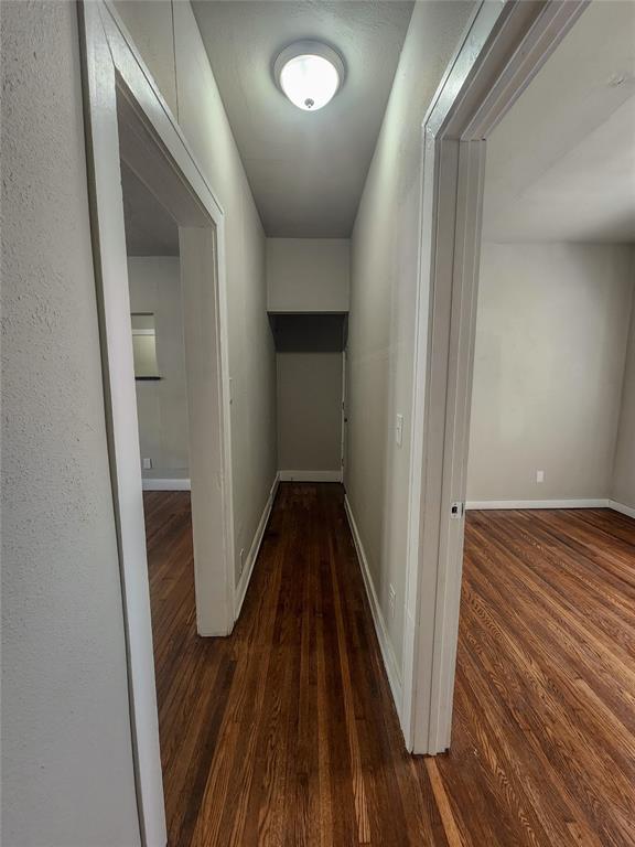 corridor featuring dark wood-type flooring