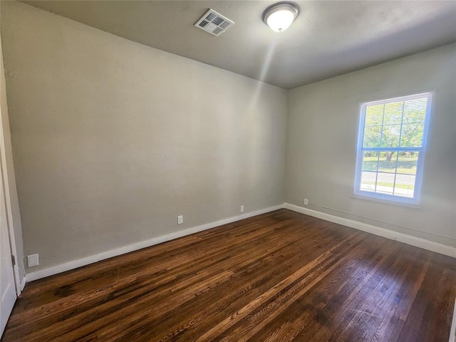 empty room with dark hardwood / wood-style floors