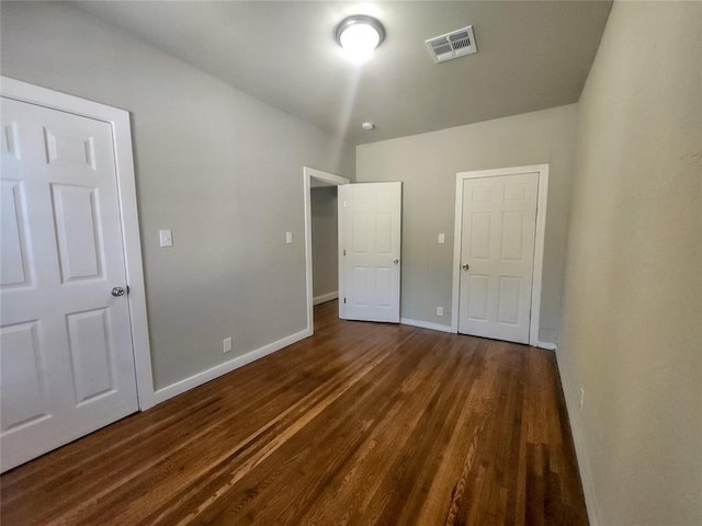 unfurnished bedroom featuring dark wood-type flooring