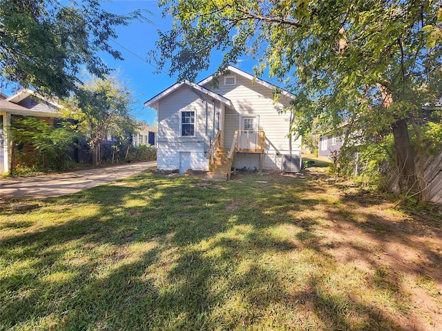 back of house with a lawn