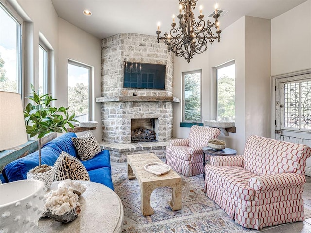 living room with a notable chandelier and a fireplace