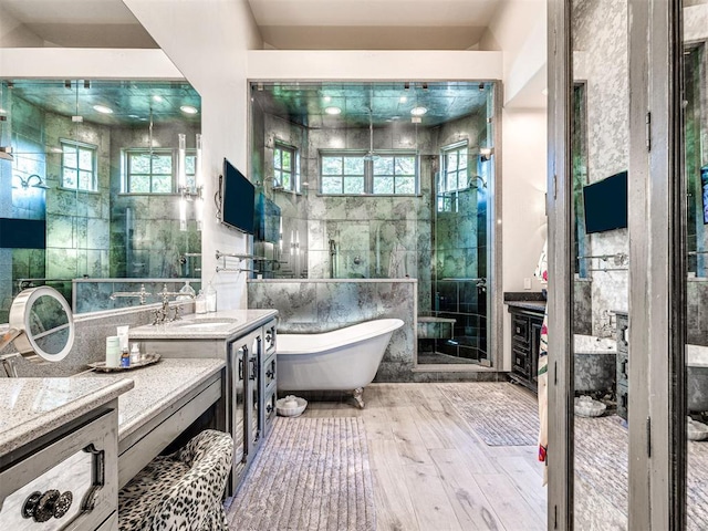 bathroom featuring hardwood / wood-style flooring, vanity, tile walls, and independent shower and bath