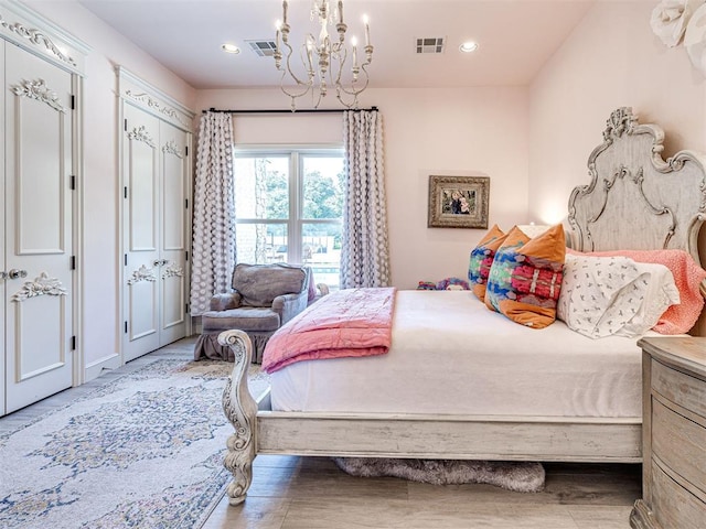 bedroom featuring hardwood / wood-style flooring and a notable chandelier