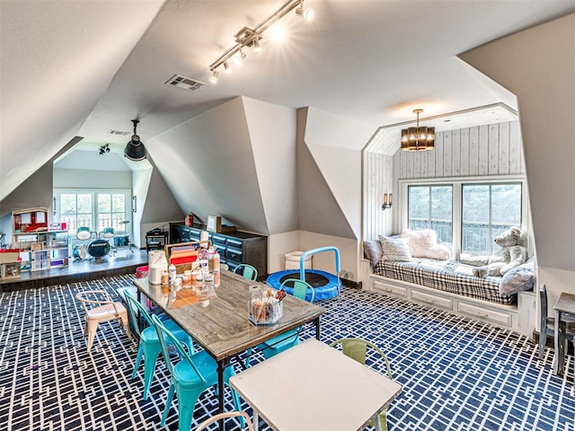 bonus room featuring lofted ceiling and a notable chandelier