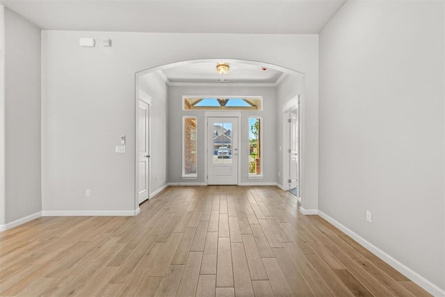 entrance foyer featuring light hardwood / wood-style floors and crown molding