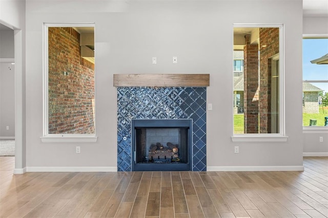 unfurnished living room featuring hardwood / wood-style flooring and plenty of natural light