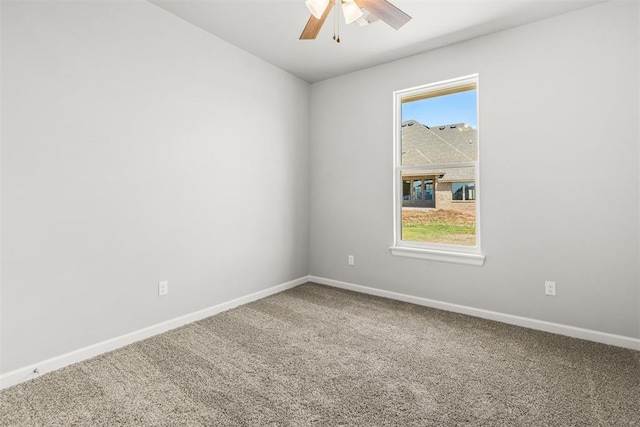 carpeted spare room with ceiling fan