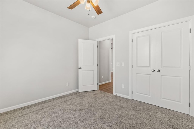 unfurnished bedroom with carpet floors, a closet, and ceiling fan