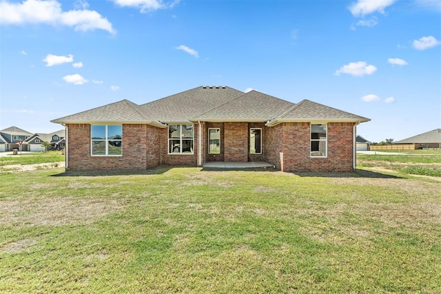 view of front of home with a front yard and a patio