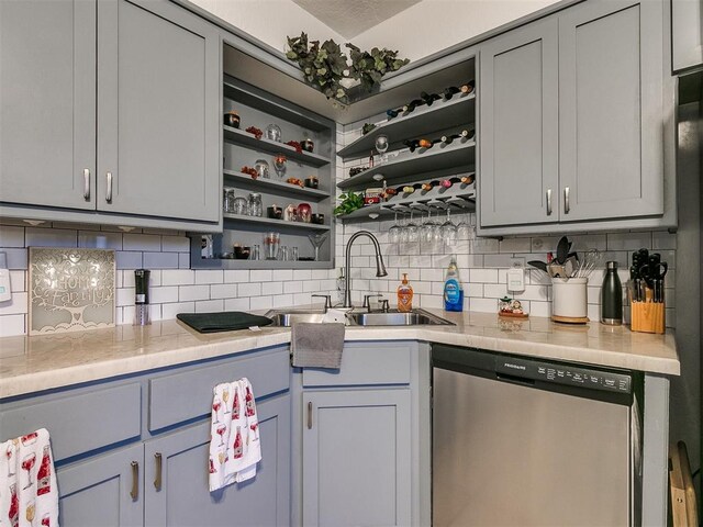 kitchen with dishwasher, gray cabinets, tasteful backsplash, and sink