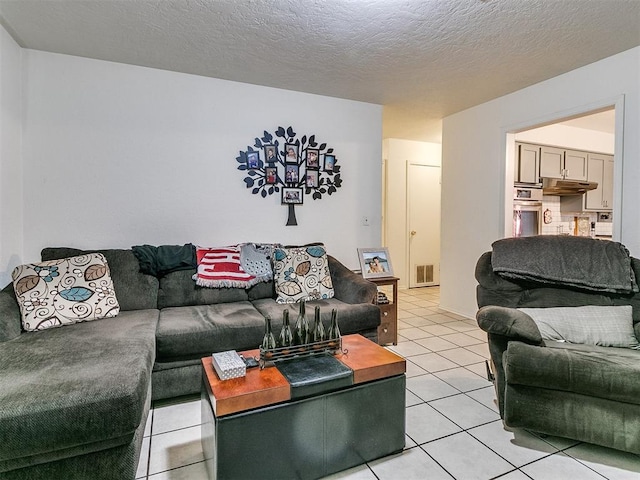 living room with light tile patterned floors and a textured ceiling