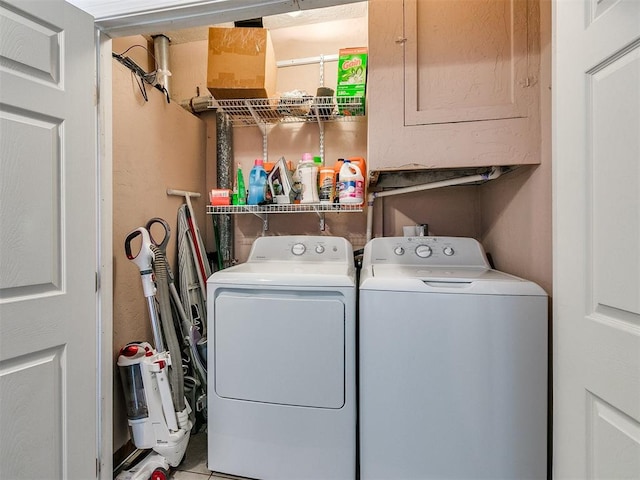 laundry room featuring washer and clothes dryer and light tile patterned floors