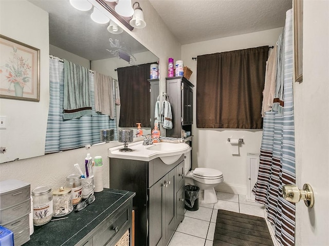 bathroom featuring tile patterned floors, vanity, a textured ceiling, and toilet