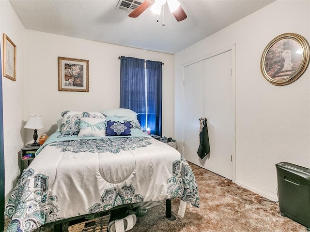 carpeted bedroom with ceiling fan and a closet