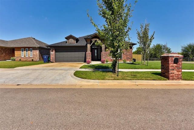 view of front of home featuring a garage and a front lawn