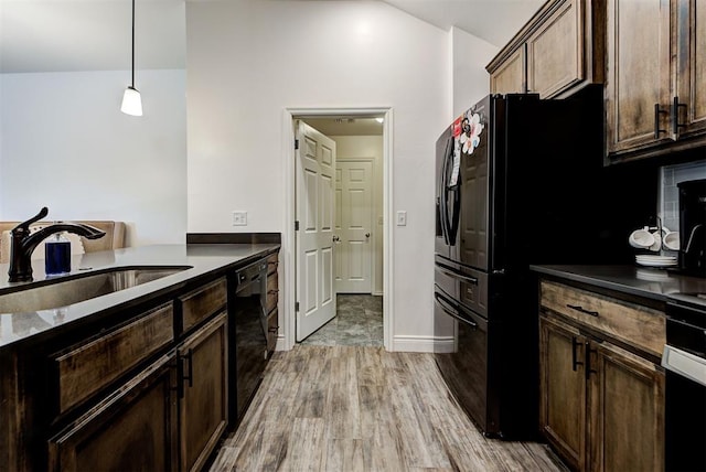 kitchen featuring black appliances, sink, decorative light fixtures, light hardwood / wood-style floors, and dark brown cabinets