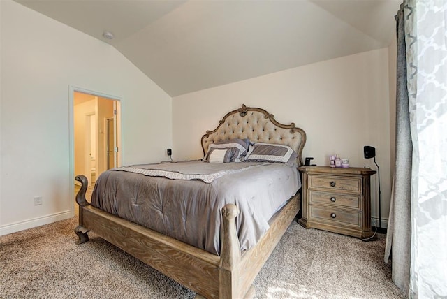 carpeted bedroom with lofted ceiling