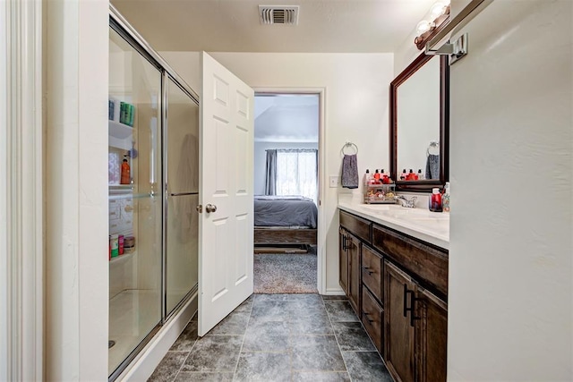 bathroom with vanity and a shower with shower door