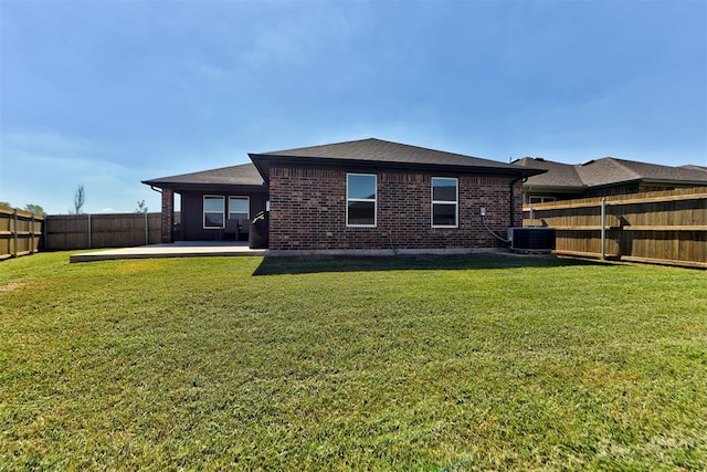 back of house with a yard, a patio, and central air condition unit