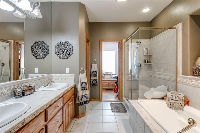 bathroom with tile patterned flooring, vanity, and plus walk in shower