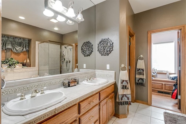 bathroom with tile patterned flooring, vanity, and a shower with shower door