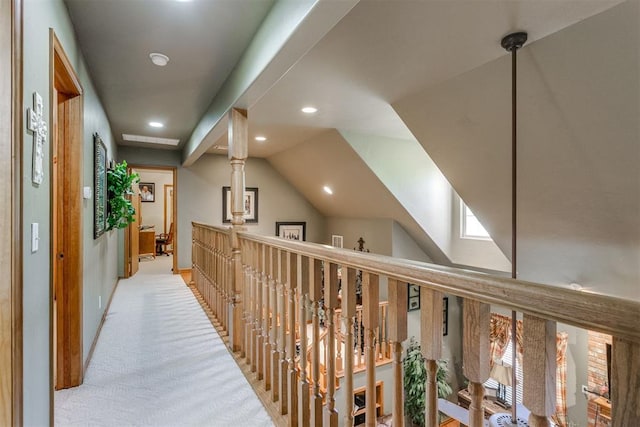 corridor featuring light carpet and lofted ceiling