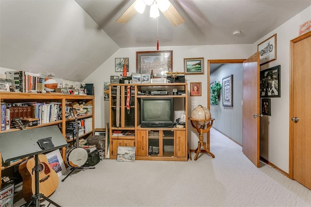 office space featuring ceiling fan, light colored carpet, and vaulted ceiling