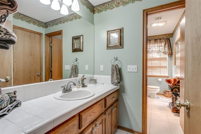 bathroom featuring tile patterned floors, vanity, and toilet