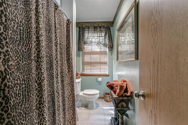 bathroom featuring tile patterned flooring, plenty of natural light, and toilet