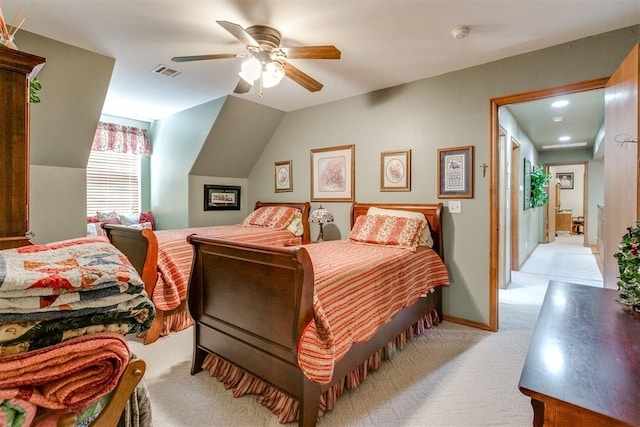 bedroom featuring light carpet, vaulted ceiling, and ceiling fan