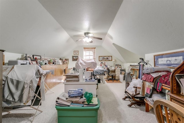 bedroom with carpet, ceiling fan, a textured ceiling, and vaulted ceiling