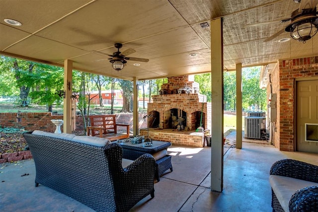 view of patio / terrace featuring an outdoor living space with a fireplace, central AC, and ceiling fan