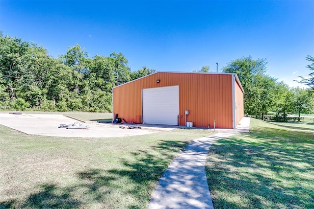 view of outdoor structure with a yard and a garage