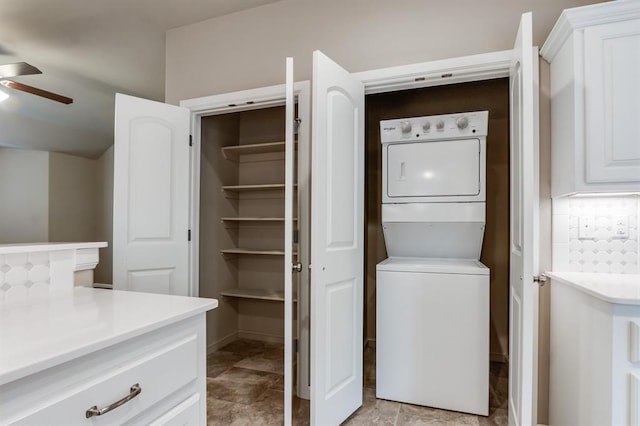 laundry room with ceiling fan and stacked washing maching and dryer