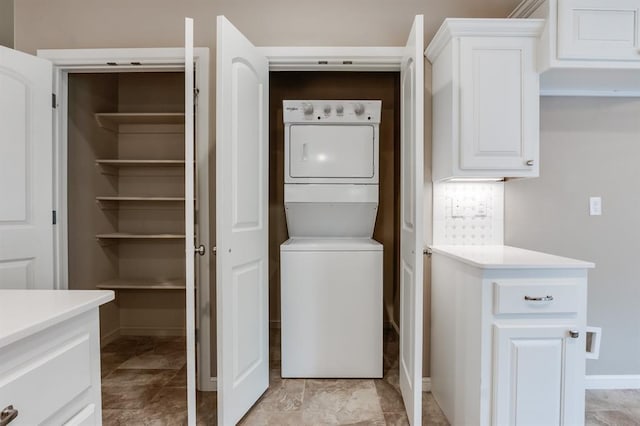 laundry area with stacked washer and dryer