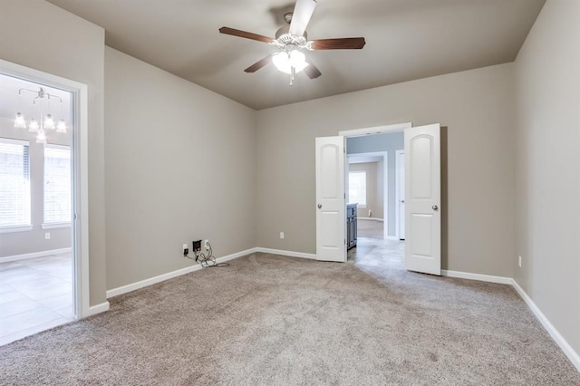 empty room featuring ceiling fan and light colored carpet