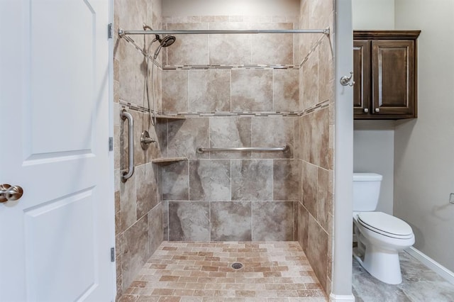 bathroom featuring toilet and tiled shower