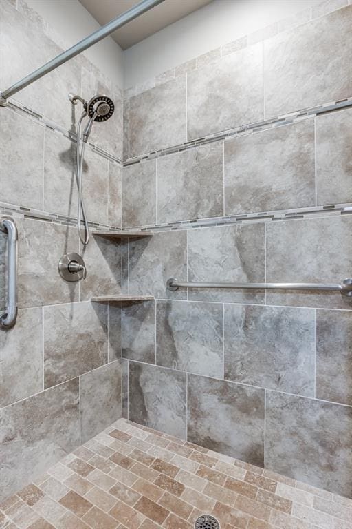 interior details featuring a tile shower