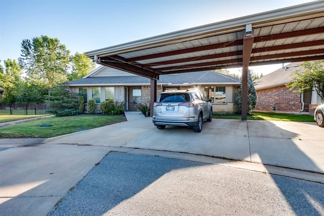 view of car parking featuring a yard and a carport