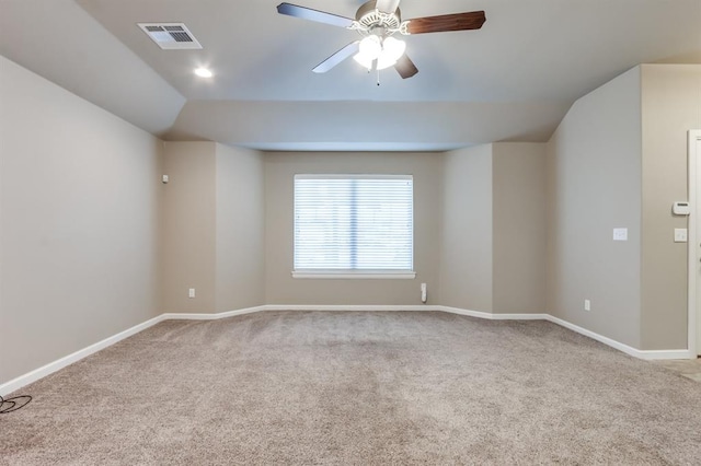 unfurnished room featuring light colored carpet, vaulted ceiling, and ceiling fan