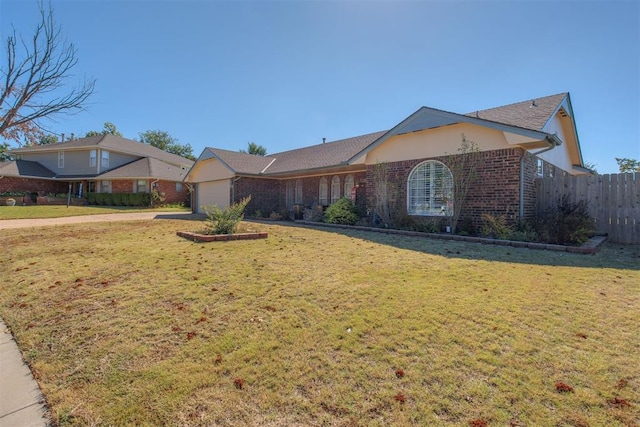 ranch-style house with a garage and a front yard