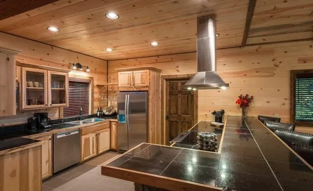 kitchen with wooden ceiling, wooden walls, appliances with stainless steel finishes, kitchen peninsula, and island exhaust hood