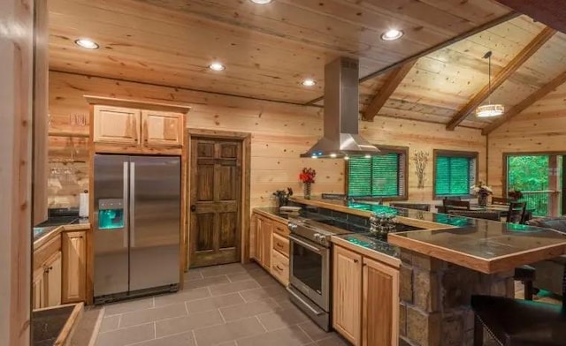 kitchen featuring island exhaust hood, appliances with stainless steel finishes, kitchen peninsula, wooden walls, and lofted ceiling with beams