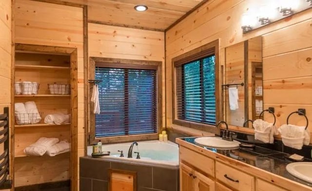 bathroom with a bathtub, wood walls, wooden ceiling, and vanity