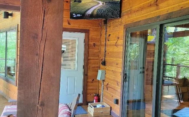 entryway featuring wood walls