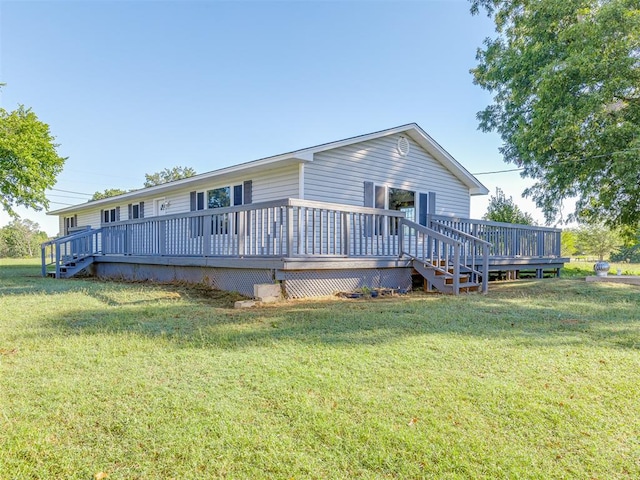 rear view of house with a lawn and a wooden deck