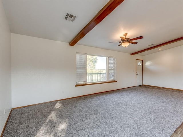 spare room featuring beam ceiling, ceiling fan, and carpet flooring